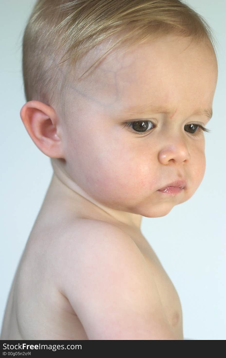 Image of beautiful toddler looking over his shoulder. Image of beautiful toddler looking over his shoulder