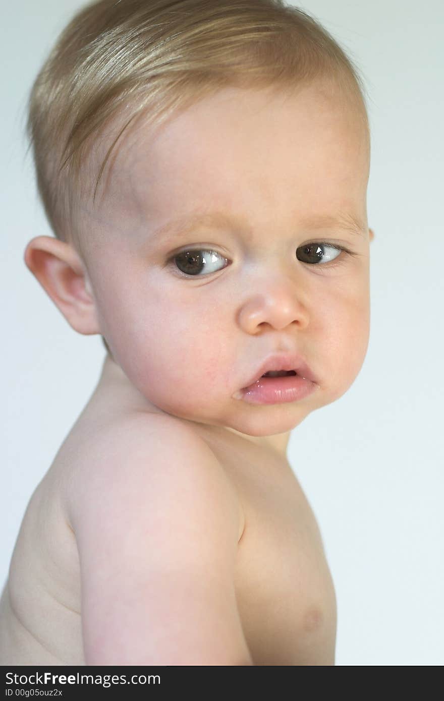 Image of beautiful toddler looking over his shoulder. Image of beautiful toddler looking over his shoulder