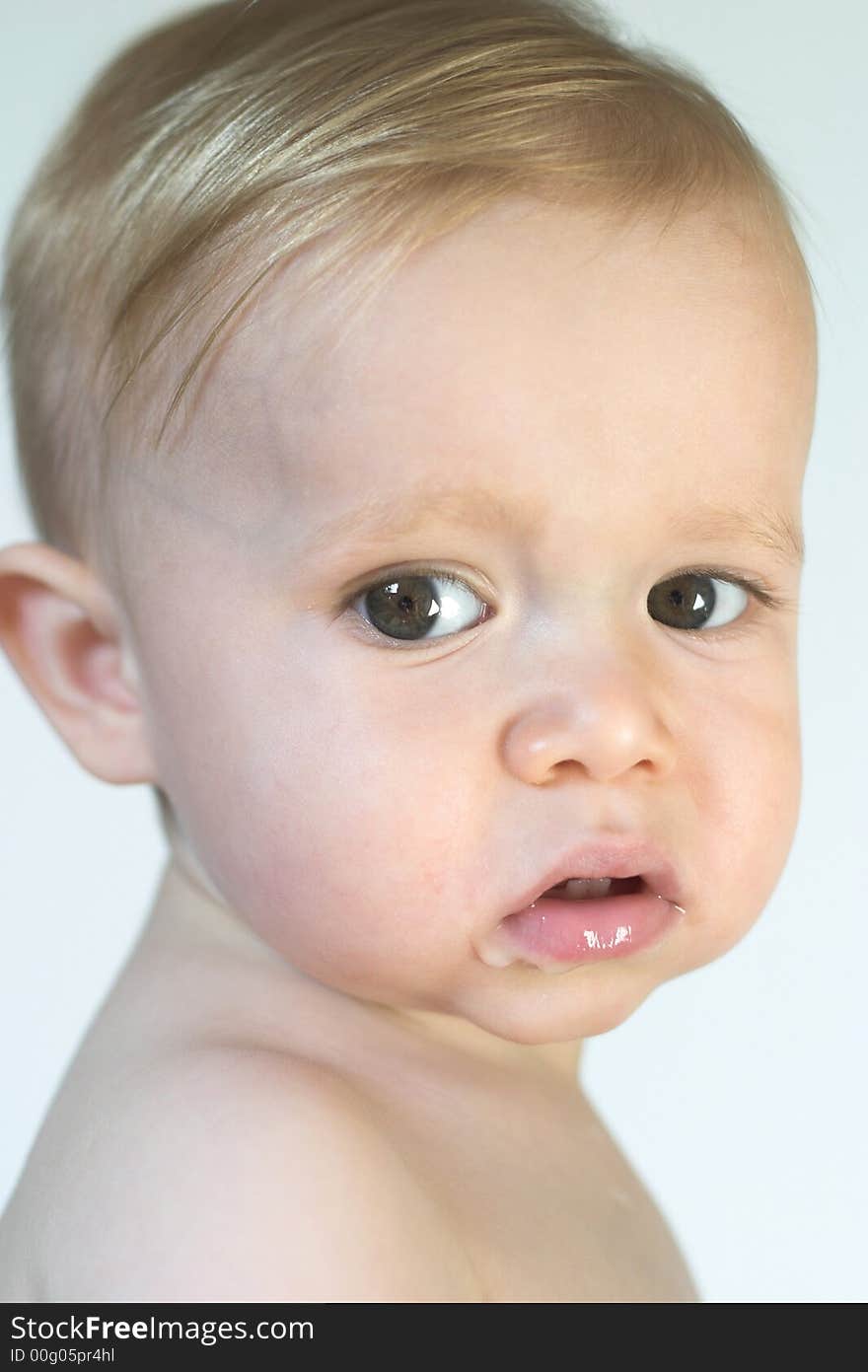 Image of beautiful toddler looking over his shoulder. Image of beautiful toddler looking over his shoulder