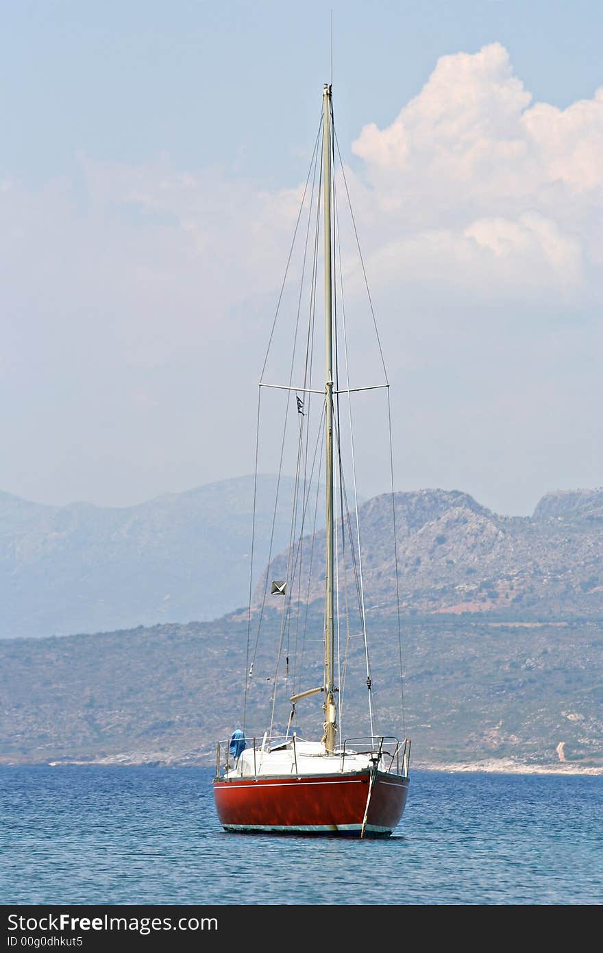 A sailing boat resting on the calm sea. A sailing boat resting on the calm sea
