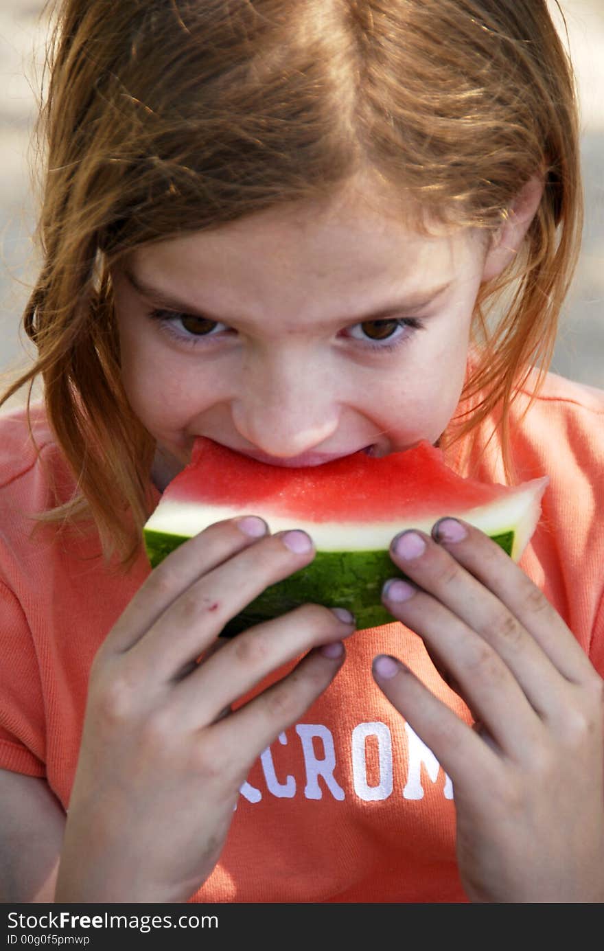 A girl is eating watermelon