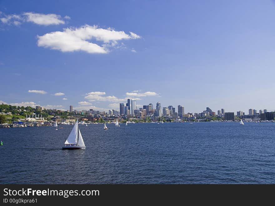 Sailboat cruising by Seattle on Lake Union. Sailboat cruising by Seattle on Lake Union