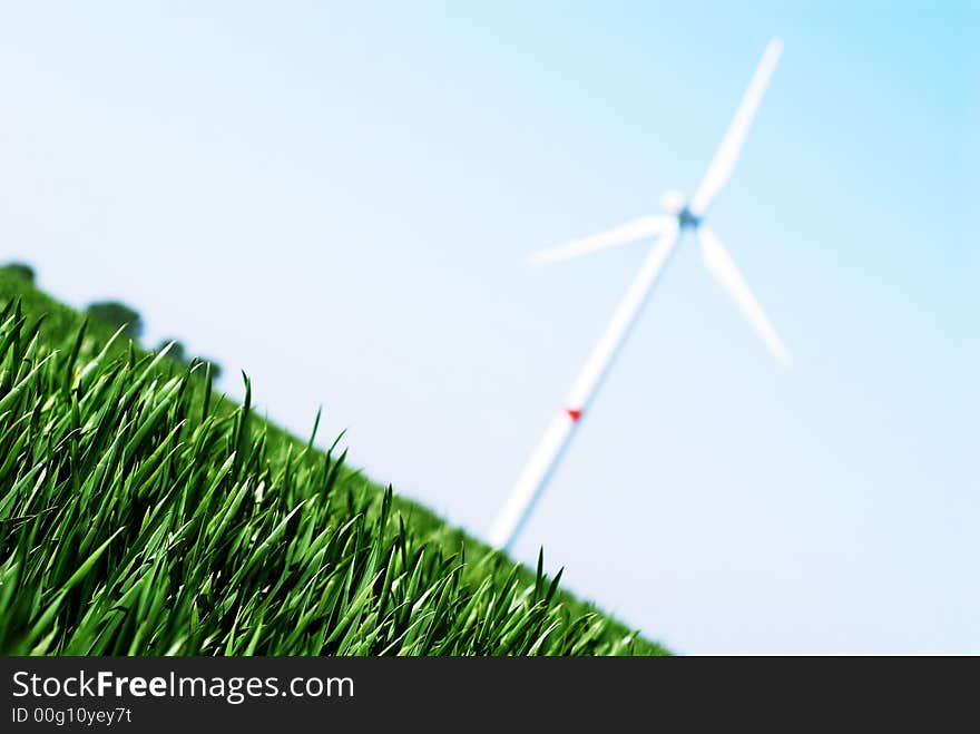 Wind turbine in a green wheat field