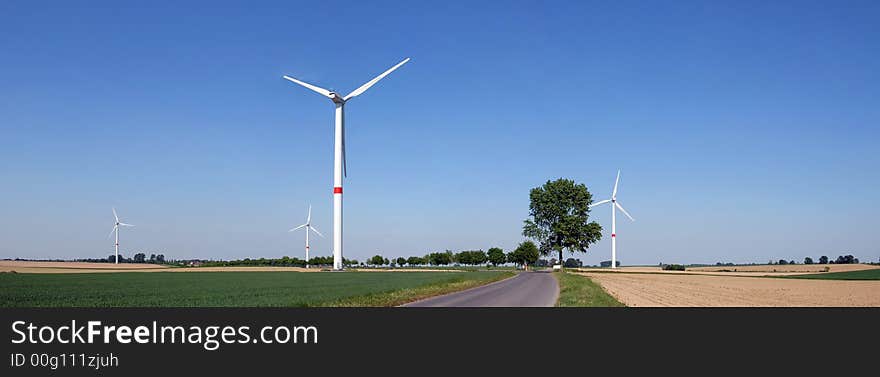 Wind turbine in a green wheat field