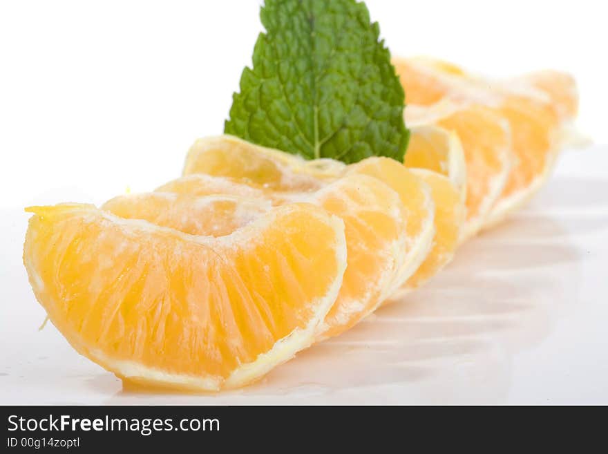 Slices of mandarin fruit and mint leaf. Slices of mandarin fruit and mint leaf