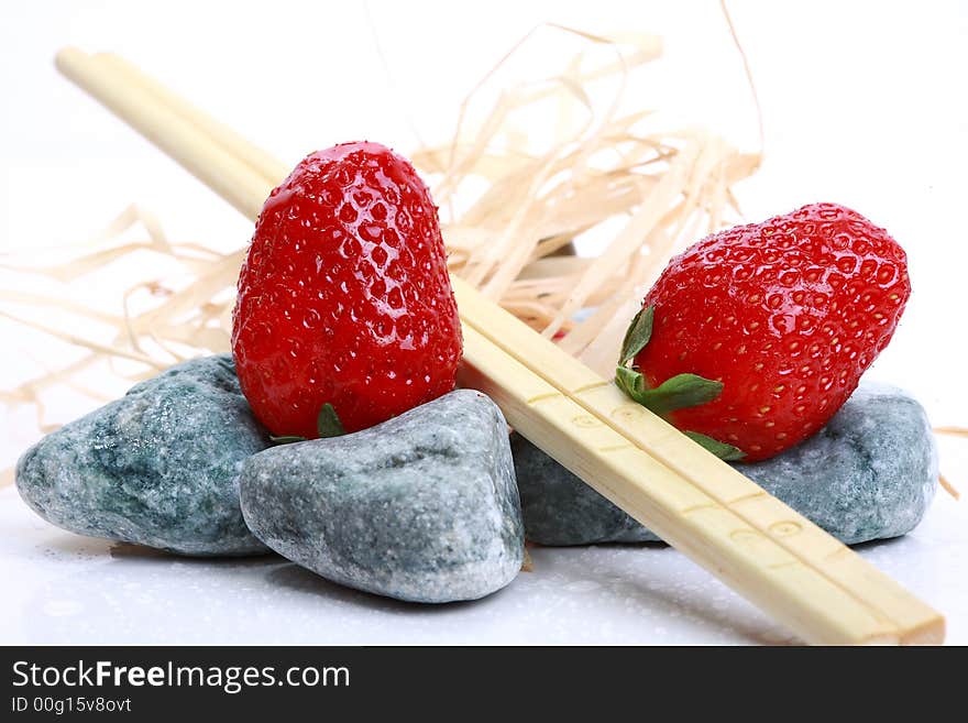 Two strawberry on grey stone with abstract decoration