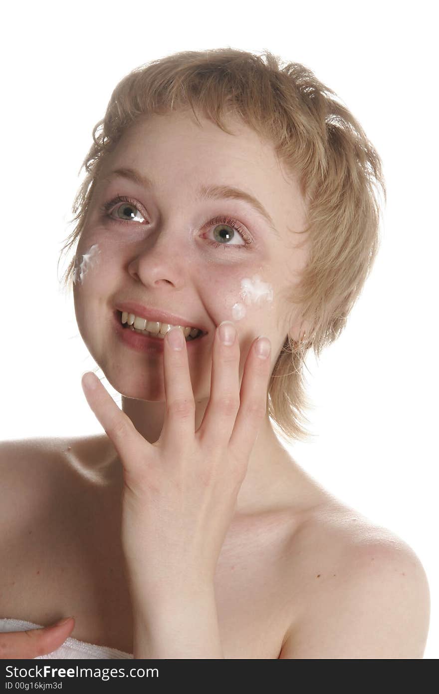 Girl applying creme on her face with hand. Girl applying creme on her face with hand