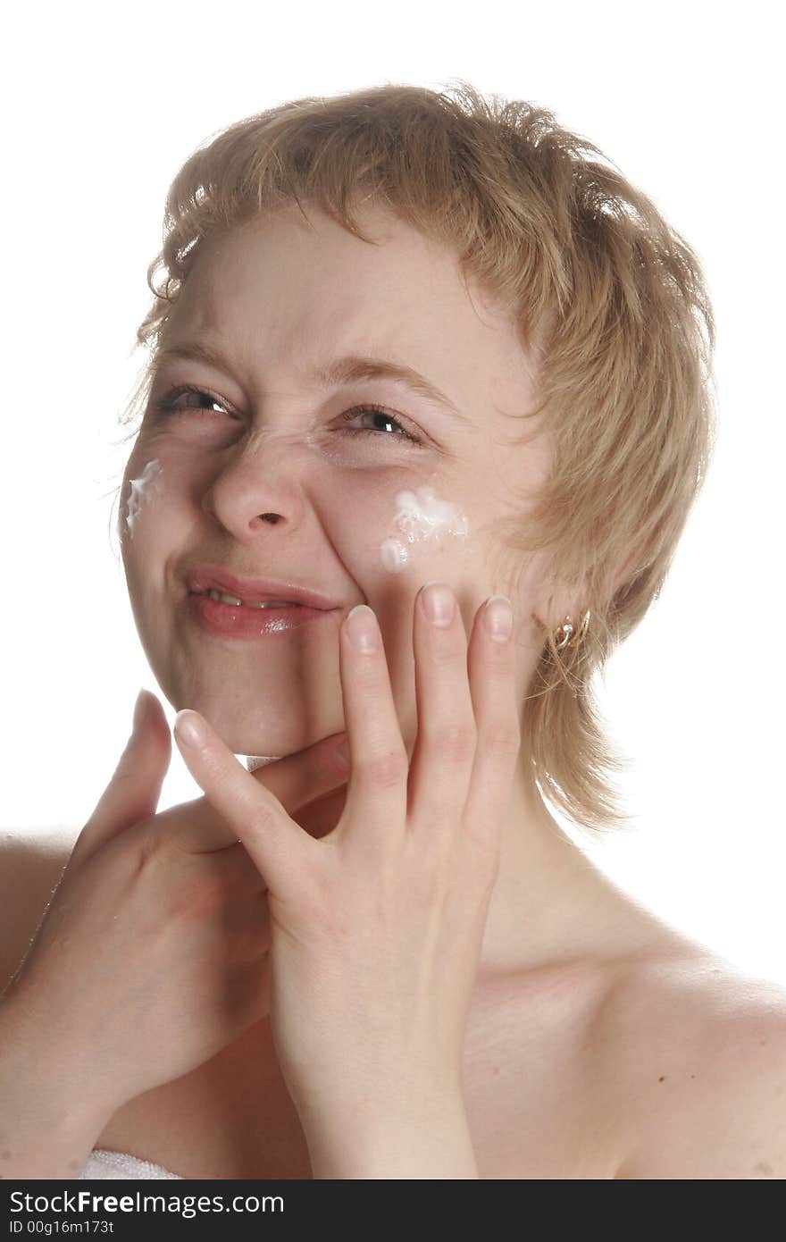 Girl applying creme on her face with hand. Girl applying creme on her face with hand