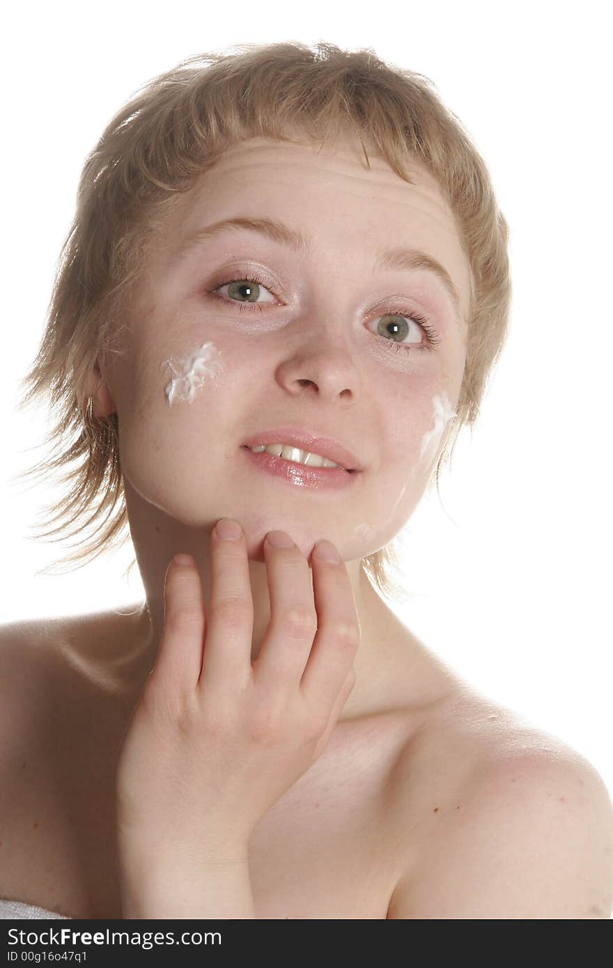 Girl applying creme on her face with hand. Girl applying creme on her face with hand