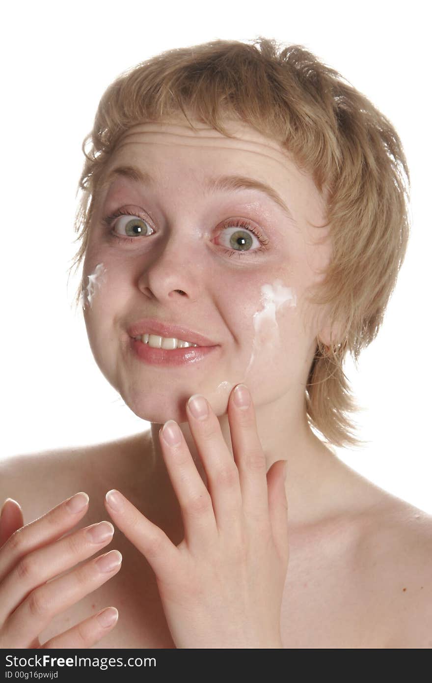 Girl applying creme on her face with hand. Girl applying creme on her face with hand