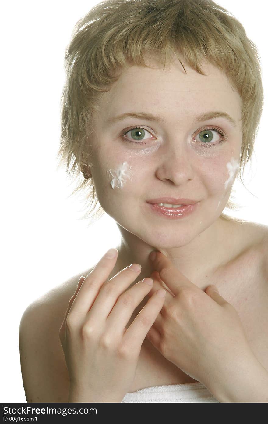 Girl applying creme on her face with hand. Girl applying creme on her face with hand