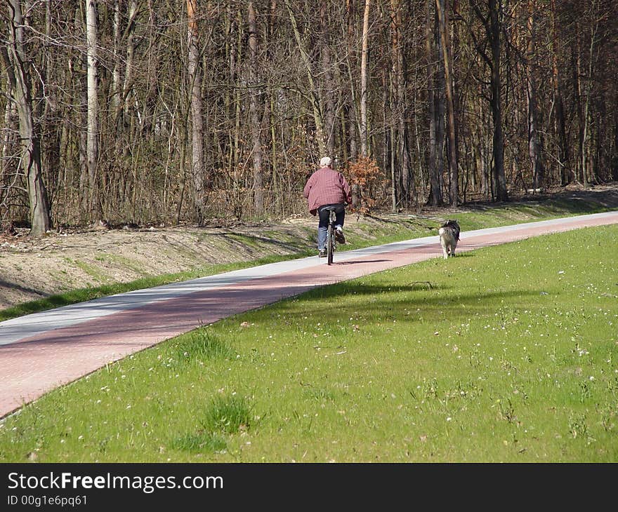 Dog is running with the bike. Dog is running with the bike