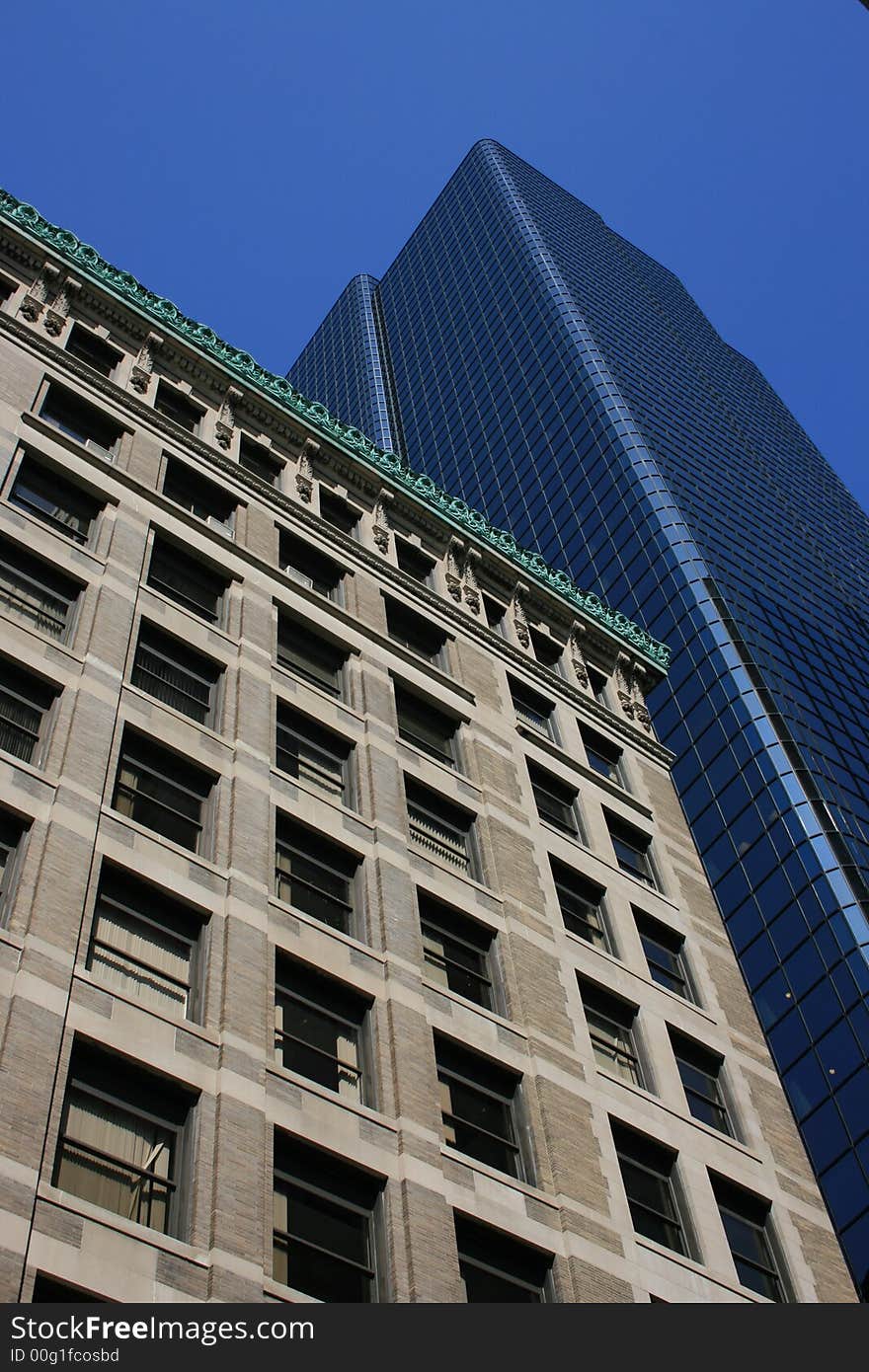 Modern, glass office tower next to an older, brick one.  Boston. Modern, glass office tower next to an older, brick one.  Boston.