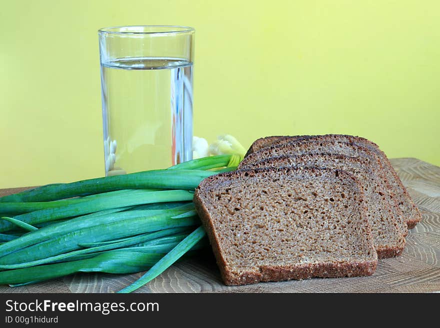 Black bread, onion and glass of water. Black bread, onion and glass of water