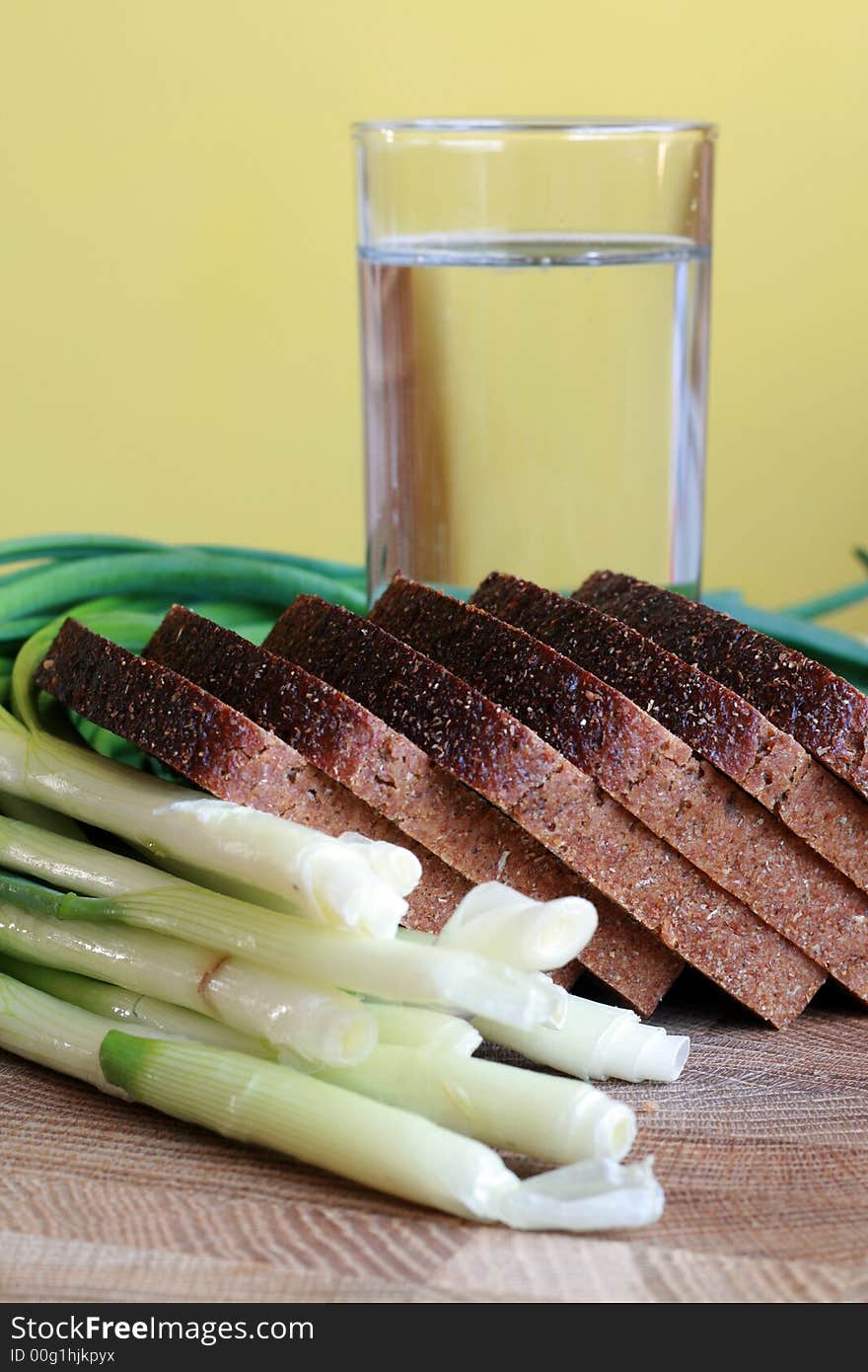 Black bread, onion and glass of water. Black bread, onion and glass of water