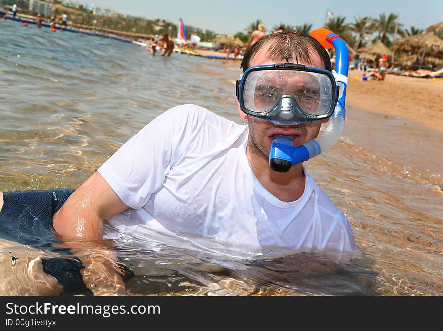 Man with snorkel in mouth in sea