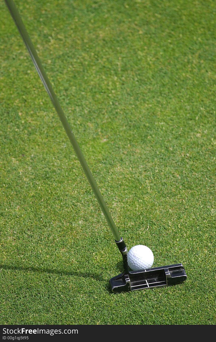 Putting the ball into the hole on the putting green