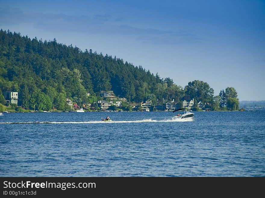 Cobalt ski boat towing a buddy on an inner tube on Lake Washington near Seattle, WA. Cobalt ski boat towing a buddy on an inner tube on Lake Washington near Seattle, WA