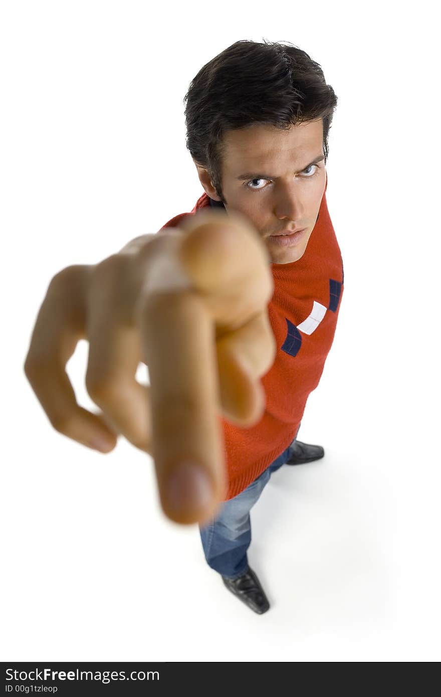 Young, handsome man wearing orange jersey, black shirt and denim jeans. Scowlingly, looking at camera. Showing by finger on camera. Isolated on white in studio, headshot. Young, handsome man wearing orange jersey, black shirt and denim jeans. Scowlingly, looking at camera. Showing by finger on camera. Isolated on white in studio, headshot