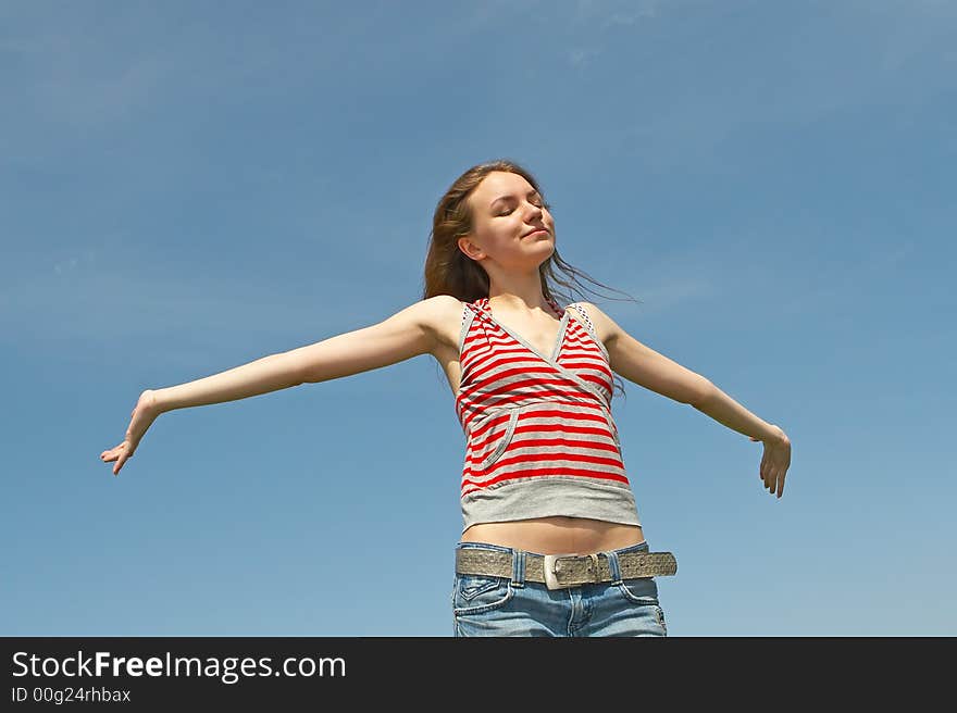 Pretty young girl on a background of the blue sky. Pretty young girl on a background of the blue sky