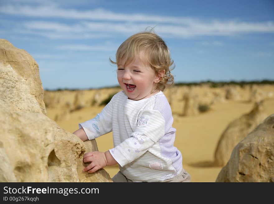 A little girl climbing on one of the Pinnacle rocks. A little girl climbing on one of the Pinnacle rocks