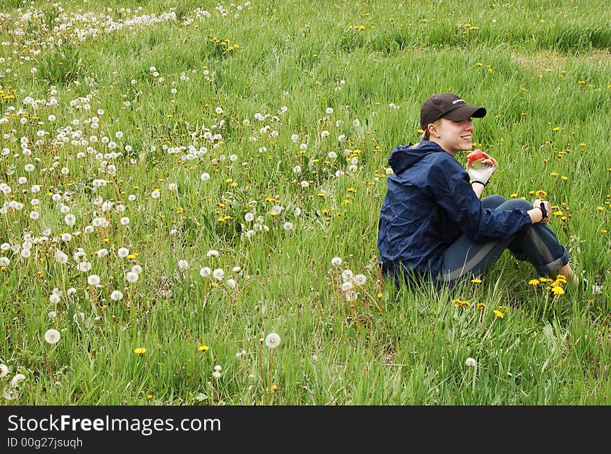 Young sporty woman  during picnic on green meadows outdoors