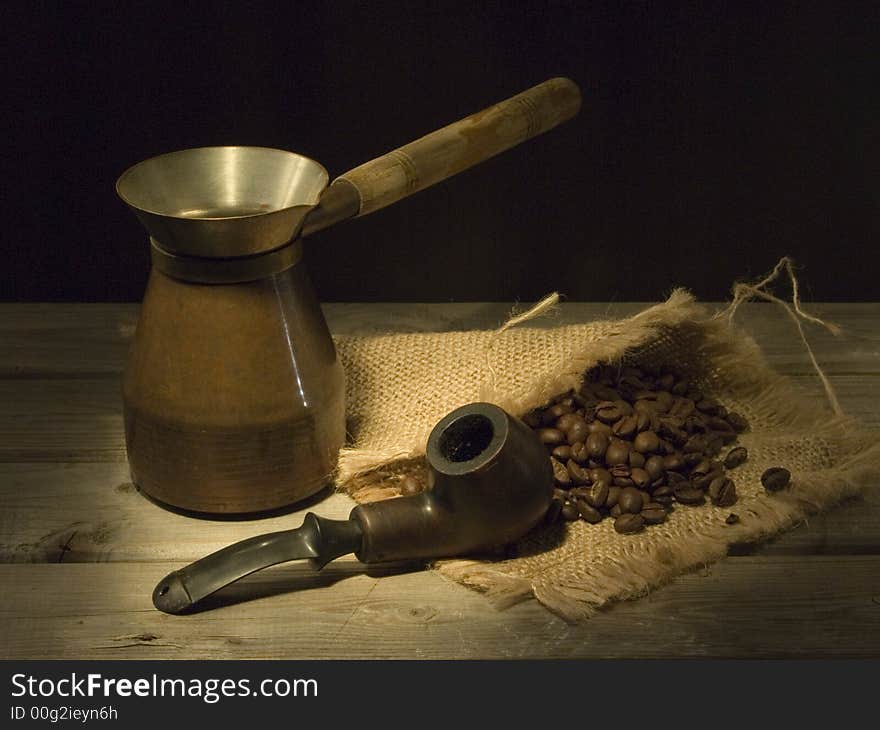 Pipe and coffee on the wooden table