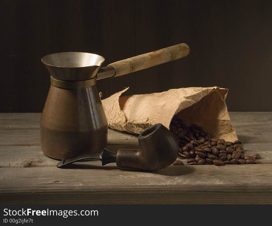 Pipe and coffee on the wooden table