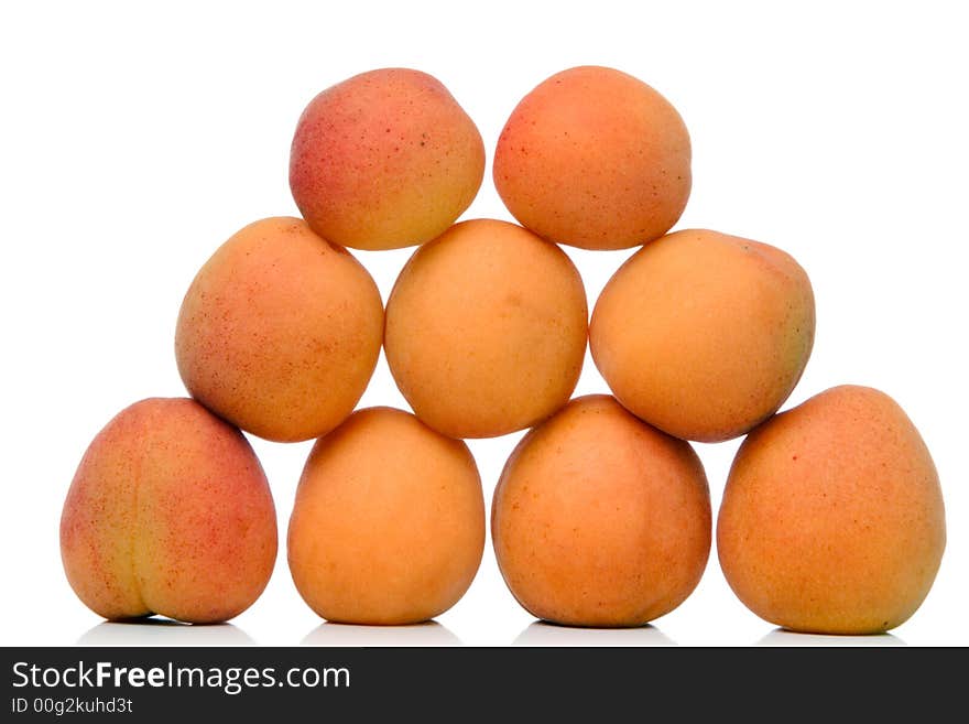 Piled apricots over white background