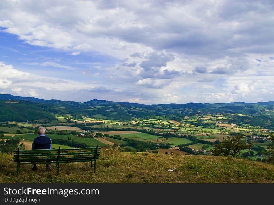 An old man contemplates the beautifl landscape in front of him, Umbria Italy. An old man contemplates the beautifl landscape in front of him, Umbria Italy