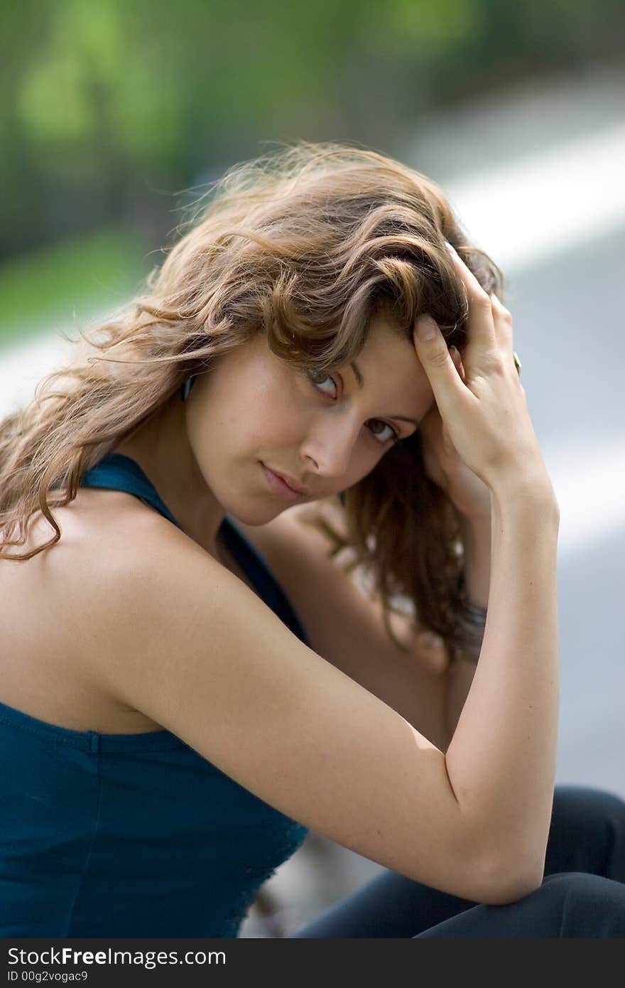 Beautiful woman sitting on a seat at park. Beautiful woman sitting on a seat at park