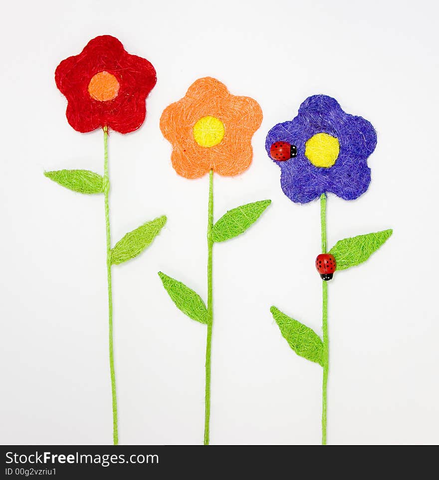 Three colorfull artificial flowers with two ladybirds. Three colorfull artificial flowers with two ladybirds