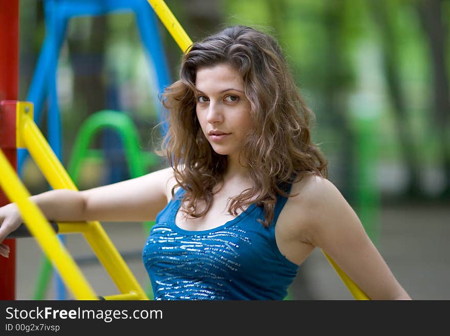 Beautiful woman sitting on a seat at park. Beautiful woman sitting on a seat at park