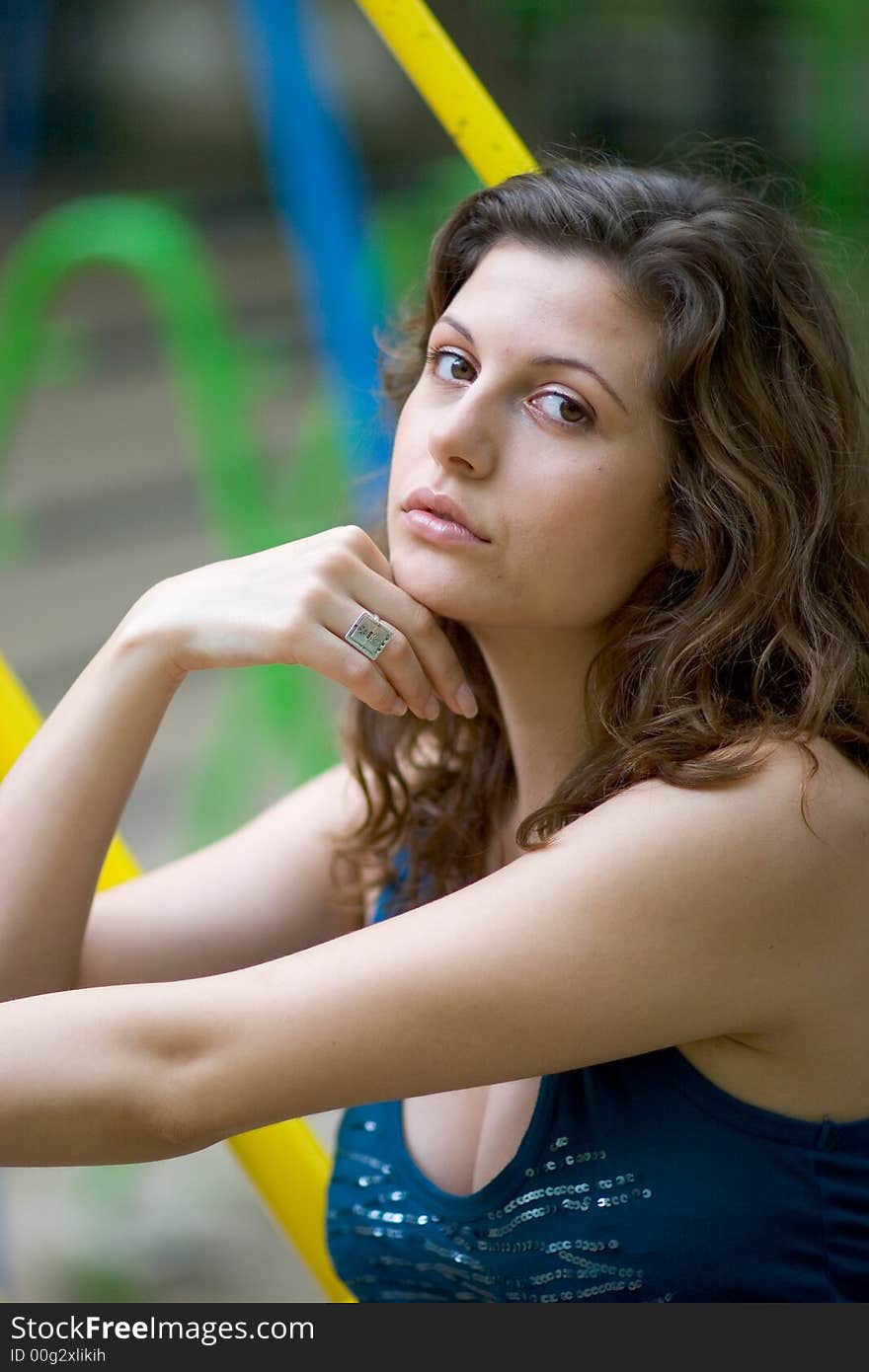 Beautiful woman sitting on a seat at park. Beautiful woman sitting on a seat at park