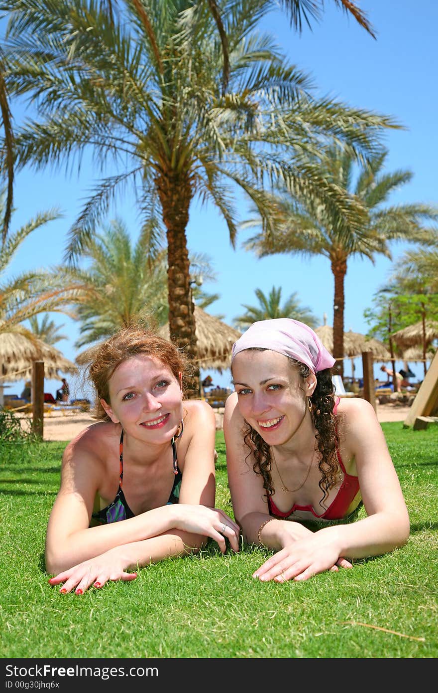 Two woman on lay on a grass