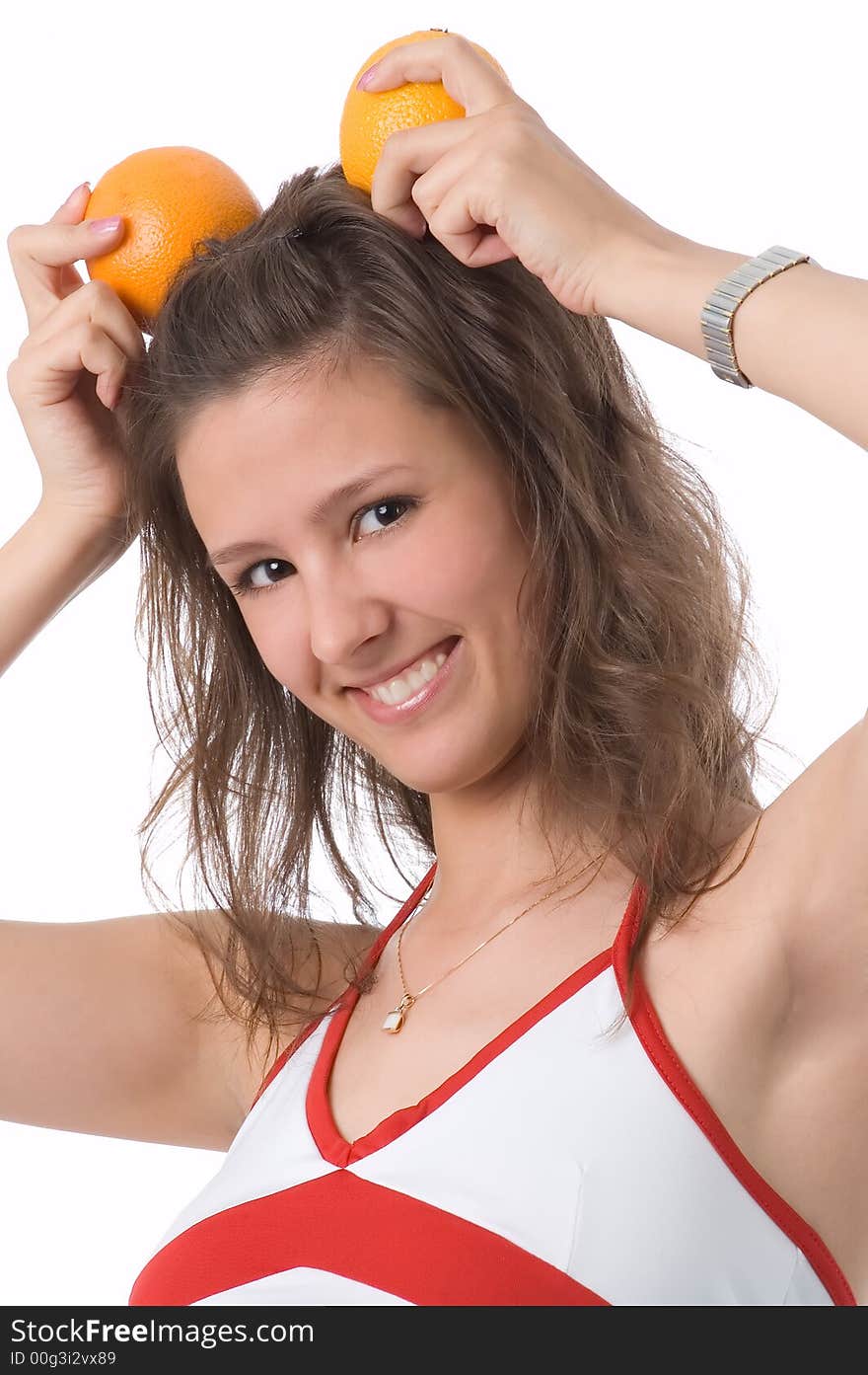 The brown-eyed girl on a white background holds oranges. The brown-eyed girl on a white background holds oranges