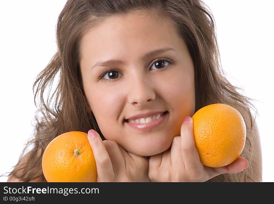 The brown-eyed girl on a white background holds oranges. The brown-eyed girl on a white background holds oranges