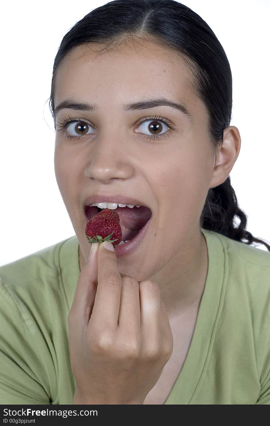 Pretty girl eating strawberry isolated