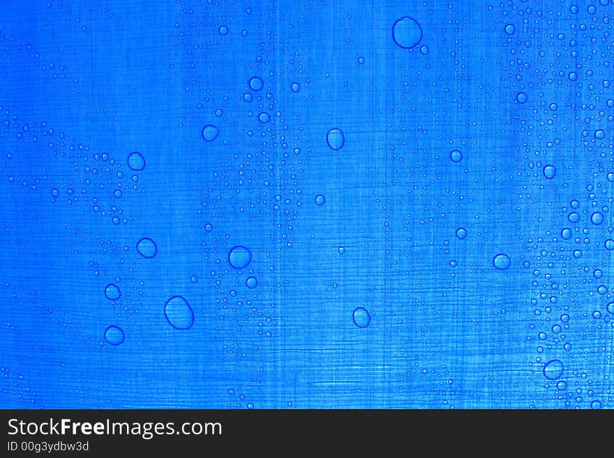 Great and small waterdrops on blue texture