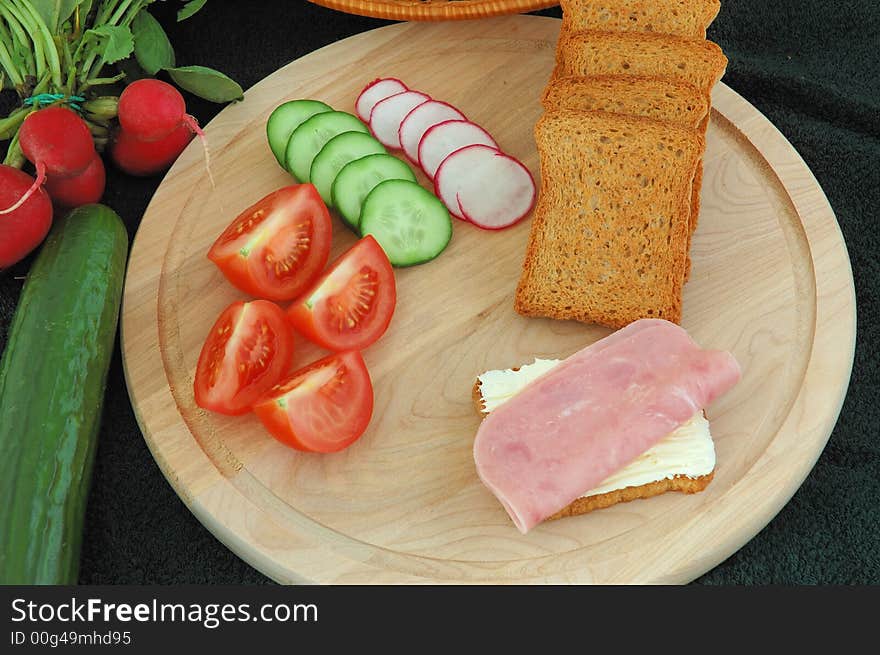 Diet cracker with butter, ham and vegetables on the table. Diet cracker with butter, ham and vegetables on the table.