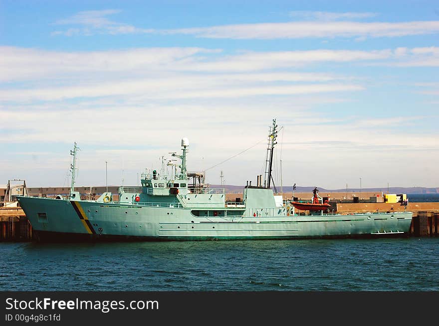 A fisheries patrol vessel in port.