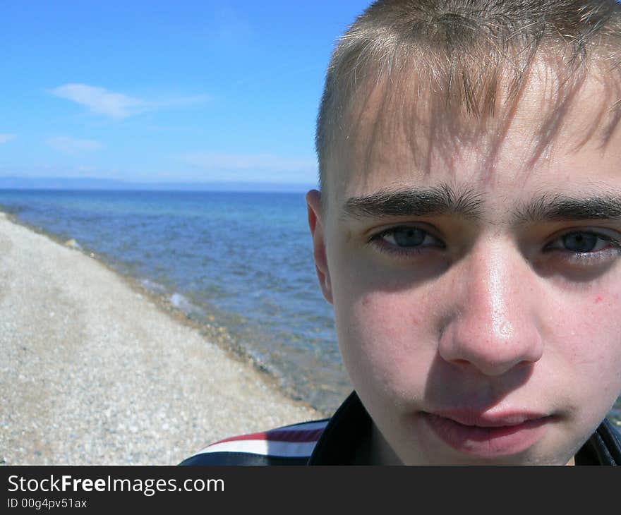 Ace of the boy on a background of Baikal. Ace of the boy on a background of Baikal