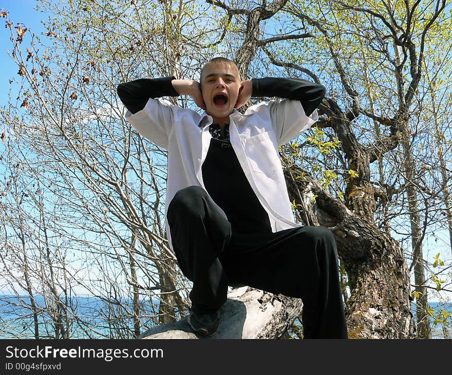 The boy cries on a background of Baikal. The boy cries on a background of Baikal