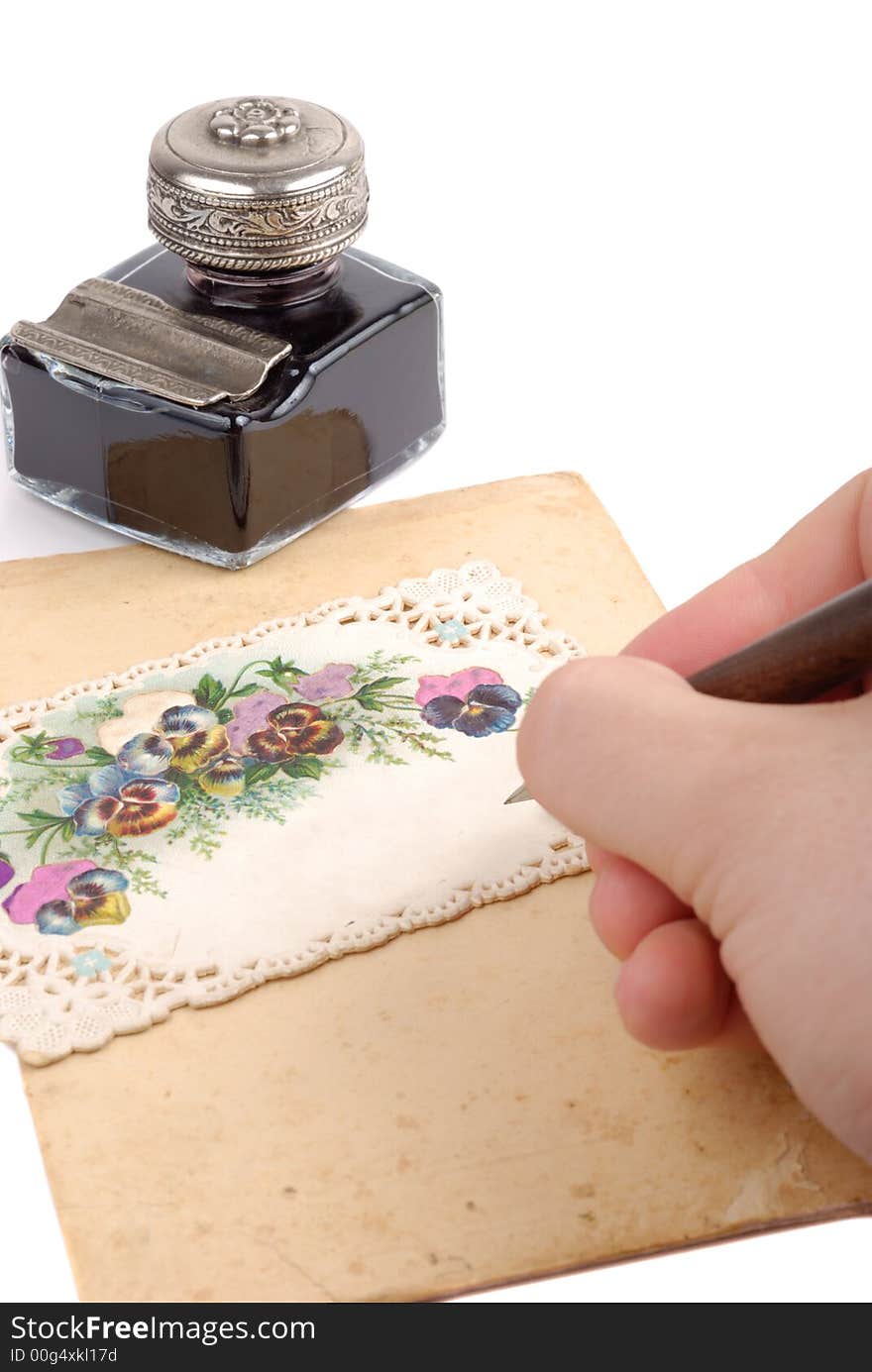 Male hand writing on postcard isolated over white background. Male hand writing on postcard isolated over white background