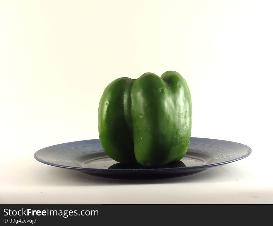 Delicious looking Green pepper on a plate. Delicious looking Green pepper on a plate