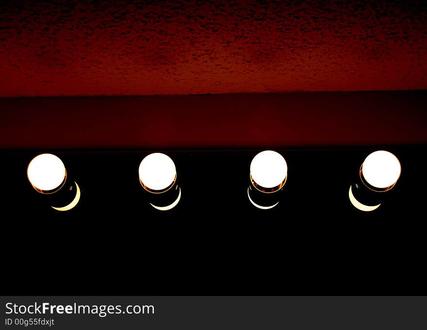 Four Light bulbs with a red background