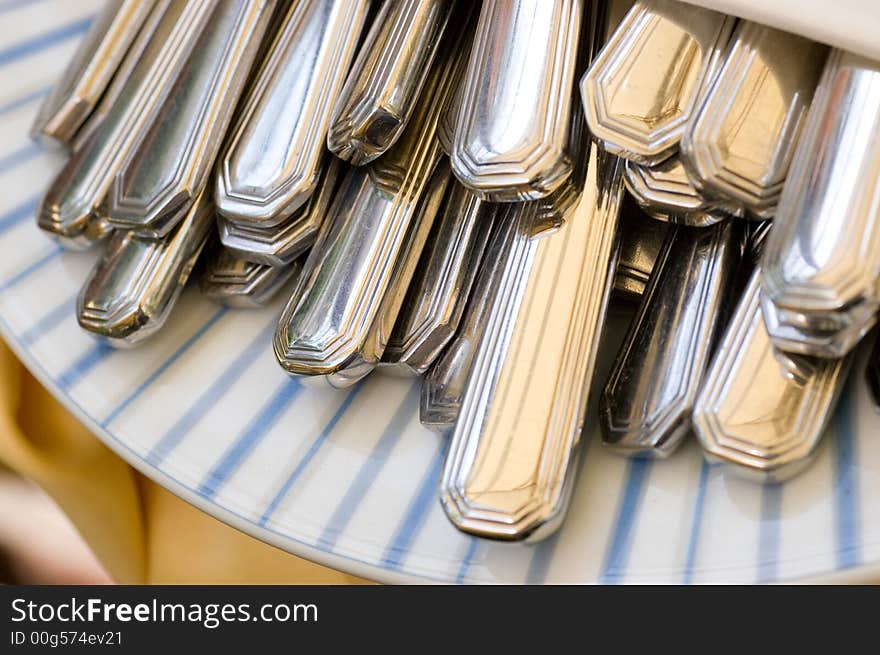 Cutlery in a napkin on a plate