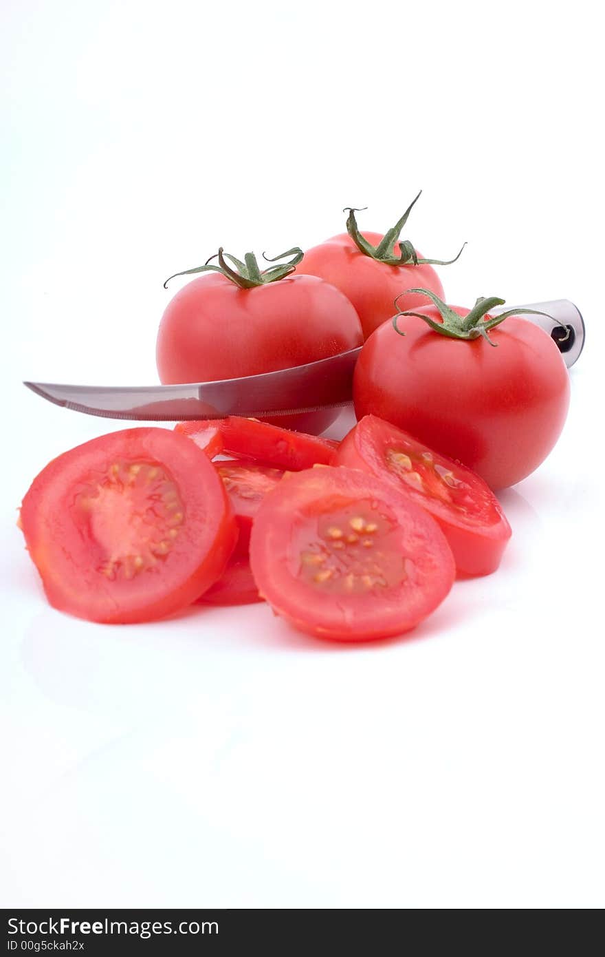 Tomato slices, whole tomatoes and a tomato knife See more food pictures. Tomato slices, whole tomatoes and a tomato knife See more food pictures.