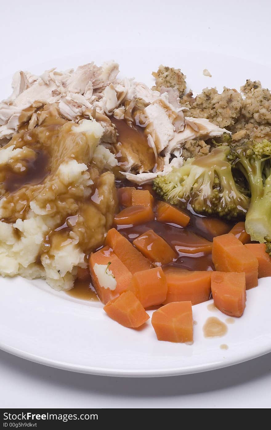 A roast dinner with chicken,carrots,brocolli and sage and onion stuffing. A roast dinner with chicken,carrots,brocolli and sage and onion stuffing