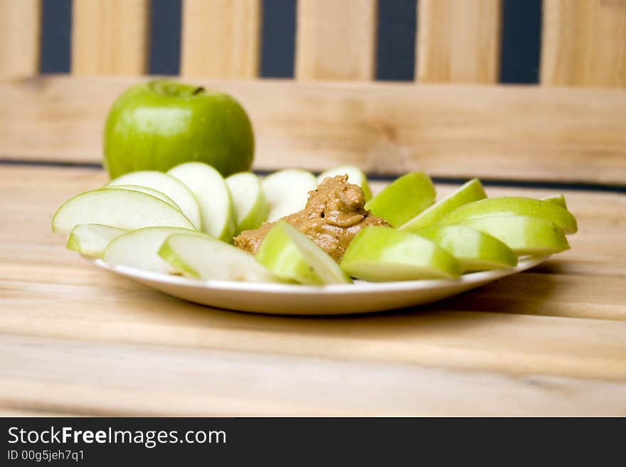 A plate of apples and peanutbutter. A plate of apples and peanutbutter